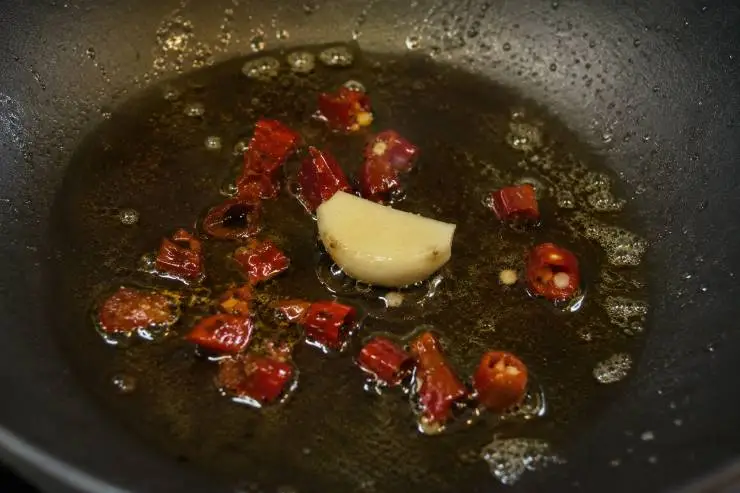 Mettete sul fuoco una pentola con acqua bollente salata. Quando bolle versate le penne rigate e fatele cuocere al dente. Versate l’olio extravergine di oliva in una padella ampia ed antiaderente e lasciatelo scaldare leggermente, quindi aggiungete lo spicchio di aglio. Unite subito anche il peperoncino e lasciatele rosolare per 1 minuto. Versate la polpa di pomodoro, mescolate e fate insaporire per 5 minuti a fiamma media.