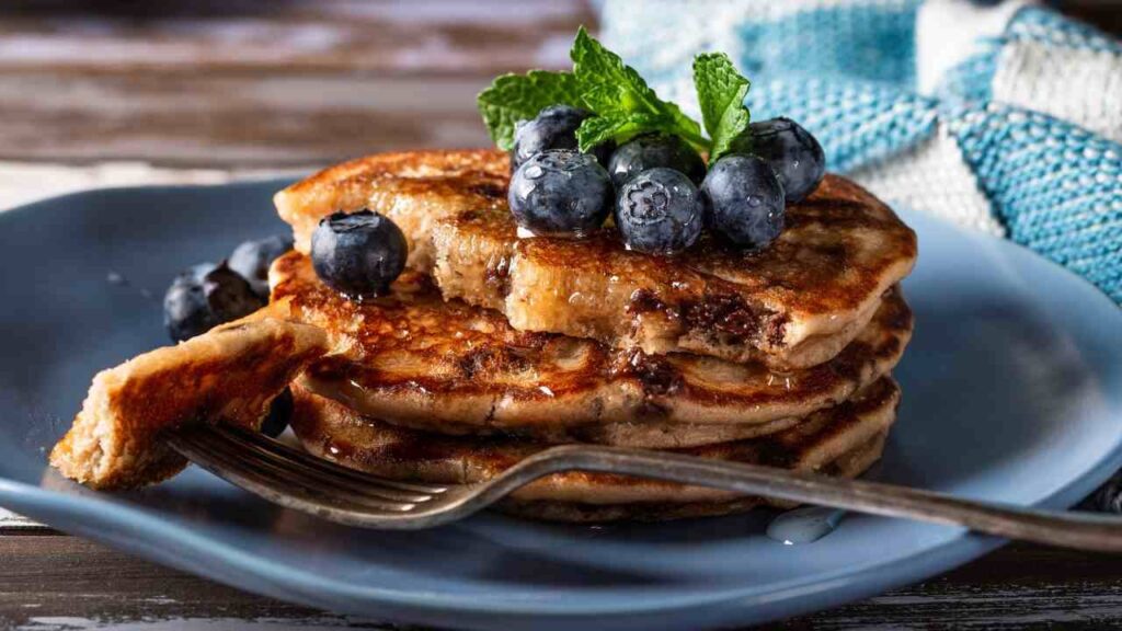 pancakes veloci morbidi senza uova burro con gocce di cioccolata ricette.com Per pancakes alti e soffici, il trucco principale è non lavorare troppo la pastella: mescolate il minimo indispensabile. Un altro trucco è lasciar riposare l'impasto 10 minuti prima di cuocerlo: il lievito inizia ad agire ed i pancakes cresceranno meglio. Se volete evitare che le gocce di cioccolato affondino, passatele prima in un cucchiaino di farina. In padella, mantenete una fiamma medio bassa: una temperatura troppo alta li brucia fuori e li lascia crudi dentro. Per una versione ancora più leggera, potete sostituire parte del latte con acqua o usare latte vegetale (soia, avena, mandorla). Varianti golose: aggiungete un cucchiaino di cacao alla pastella per pancakes "double chocolate", oppure un po' di cannella per dare un tocco natalizio. Se volete una consistenza più soffice, aggiungete un cucchiaio di yogurt. Se invece preferite pancakes più spessi, diminuite leggermente il latte. Per una colazione speciale, provate a servirli con: pere caramellate, frutti rossi, crema di nocciole, sciroppo d'acero caldo. pancakes veloci morbidi senza uova burro con gocce di cioccolata ricette.com
