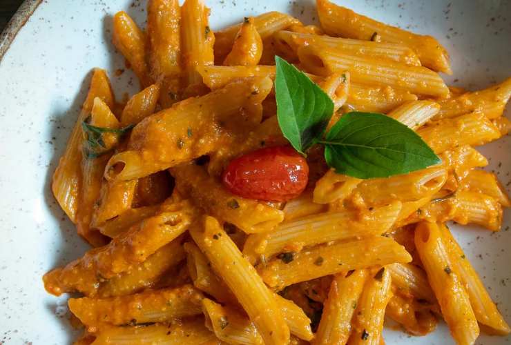 Scoliamo la pasta e portiamola in pentola. Uniamo due o tre coppini di sugo di pomodoro e panna e poi spolveriamo con il parmigiano grattugiato dopo aver distribuito nei piatti. Ricopriamo con altro sugo e via a tavola.