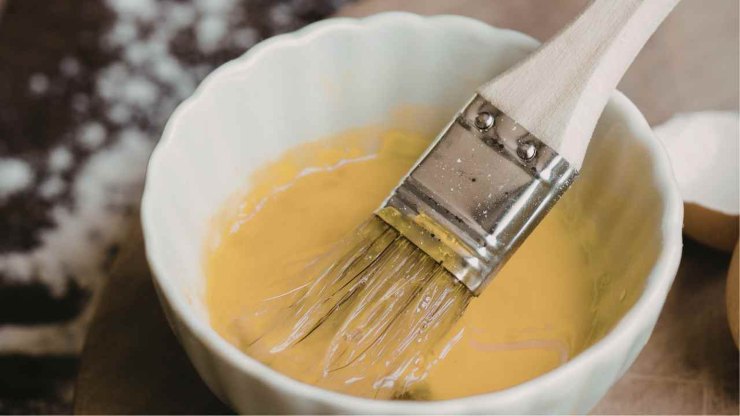 Fatto ciò, adagiate con delicatezza la seconda calza ricoprendo la prima e sigillate con i rebbi di una forchetta. Se avete tempo, potete ricavare delle decorazioni con la sfoglia avanzata, applicandole con una leggera pressione. Praticate qualche foro con i rebbi di una forchetta, spennellate tutto con il tuorlo sbattuto e trasferite in forno caldo.