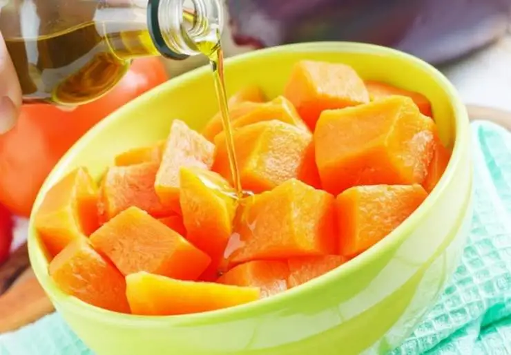 Riversiamo i pezzi di zucca in una ciotola capiente dopo aver tamponato via l’acqua in eccesso con un canovaccio pulito. Condiamo con un filo generoso di olio d’oliva e mescoliamo così da inumidire tutti i pezzetti di zucca;