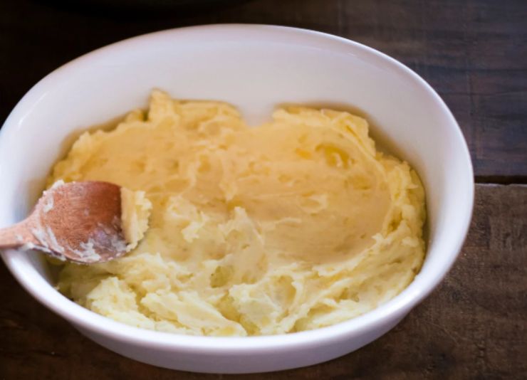 Schiacciamo la patata aiutandoci con una forchetta o con uno schiacciapatate e accorpiamo il parmigiano grattugiato, un pizzico di sale e di pepe e anche gli aromi che vogliamo. Amalgamiamo il composto di patata, lenticchie e parmigiano usando un mestolo;