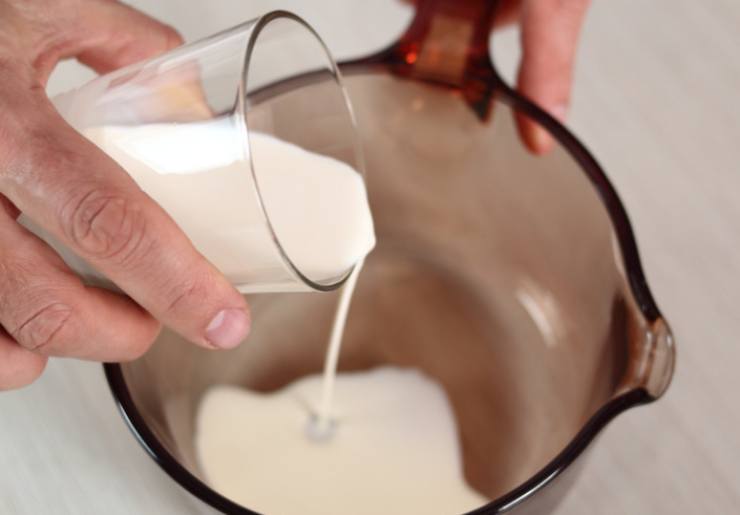 Riversiamo in un tegame la panna e il latte, quindi uniamo la pasta di nocciole e lo zucchero a velo e portiamo sul fuoco a fiamma dolce, rimescolando lentamente;