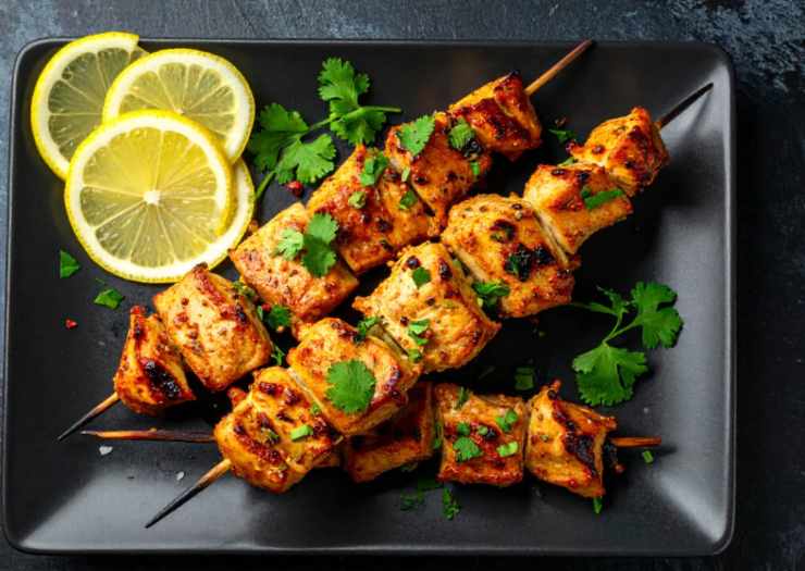 Infilziamo 4 o 5 pezzetti di pollo sui classici spiedini e adagiamo nella padella riversando il sugo rimasto nella ciotola. Uniamo il succo di mezzo limone e facciamo cuocere a fiamma media dorando prima un lato e poi gli altri. Quando il pollo sarà ben cotto spegniamo la fiamma e aggiustiamo il sale se serve. Sistemiamo in un vassoio gli spiedini ricoprendo col sughetto rimasto in padella.