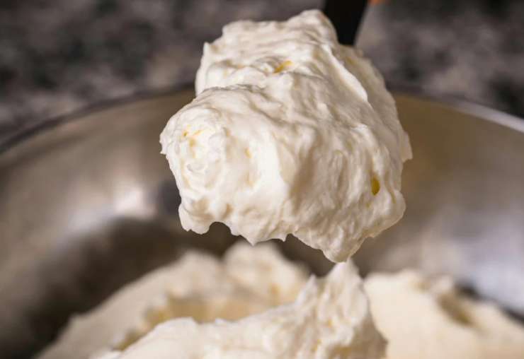 Lavoriamo con un frullino per amalgamare i due ingredienti, copriamo con della pellicola e mettiamo in frigo. Intanto sbricioliamo i biscotti secchi;