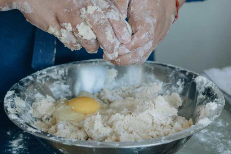 Uniamo un pizzico di sale, uno di aglio in polvere e una spolverata degli aromi che preferiamo. Mescoliamo e accorpiamo prima il parmigiano grattugiato e poi le uova. Per ultimo uniamo il lievito. Lavoriamo ancora per ottenere un composto omogeneo e semi-compatto;